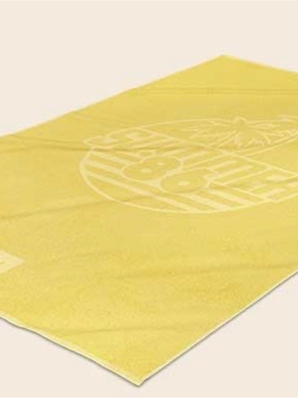 Nespresso Yuzu beach towel featuring a subtle "Summer Vibes" palm tree graphic